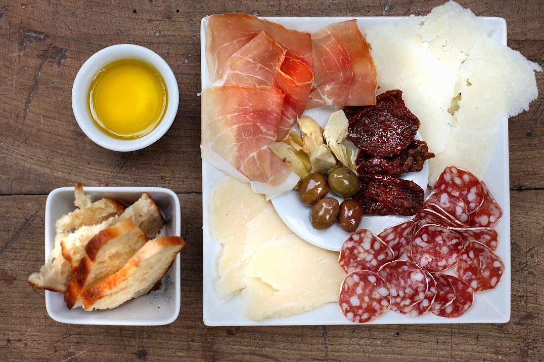 Antipasti: sundried tomatoes, olives, parmesan, Parma ham, olive oil, bread, salami, pickled artichokes