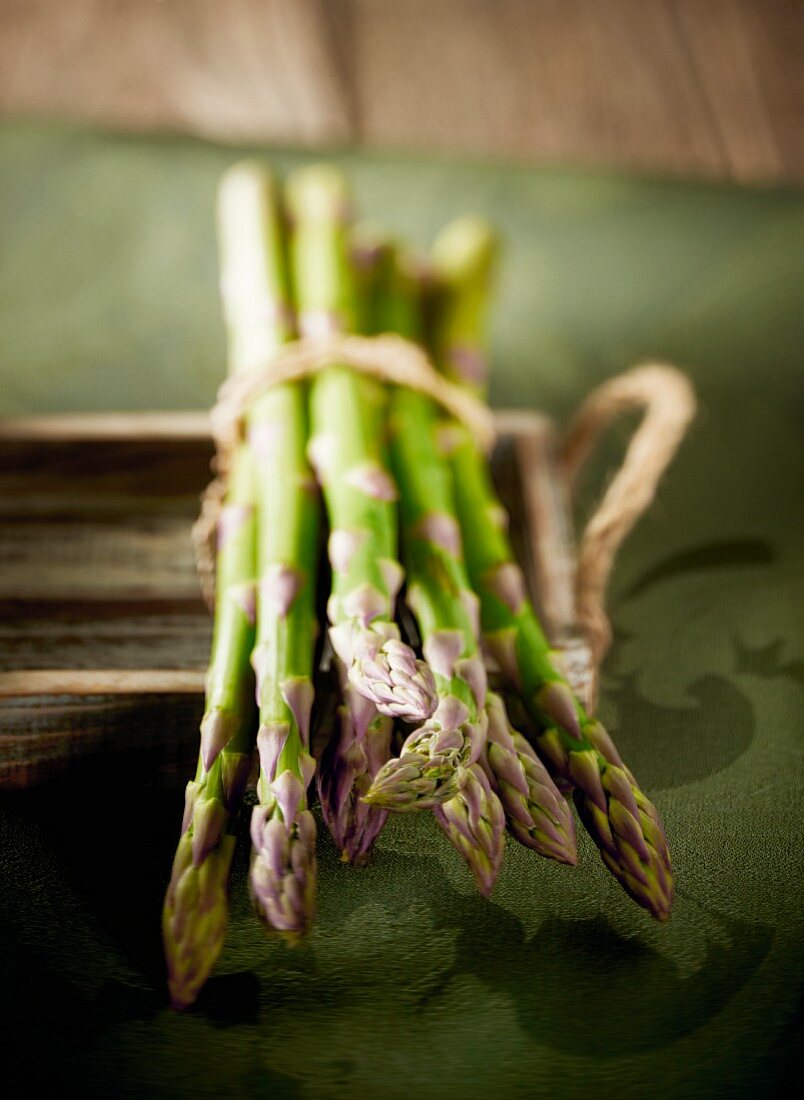 Green asparagus, bunched, on a tray