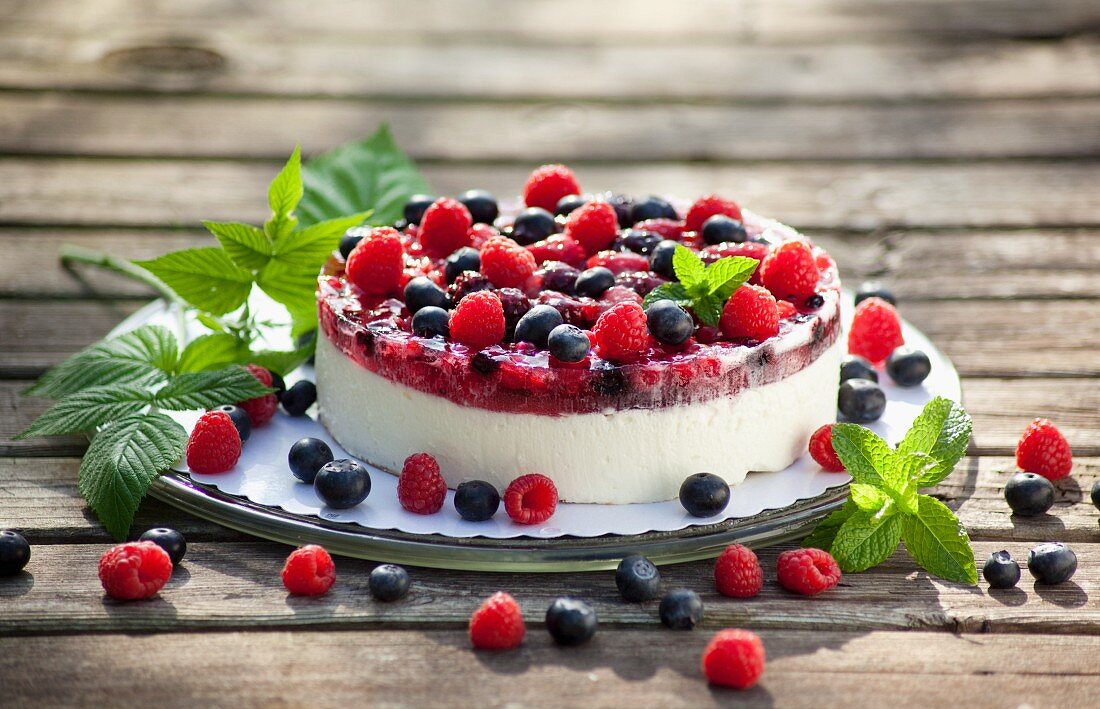 Berry layer cake with blueberries, raspberries and redcurrants