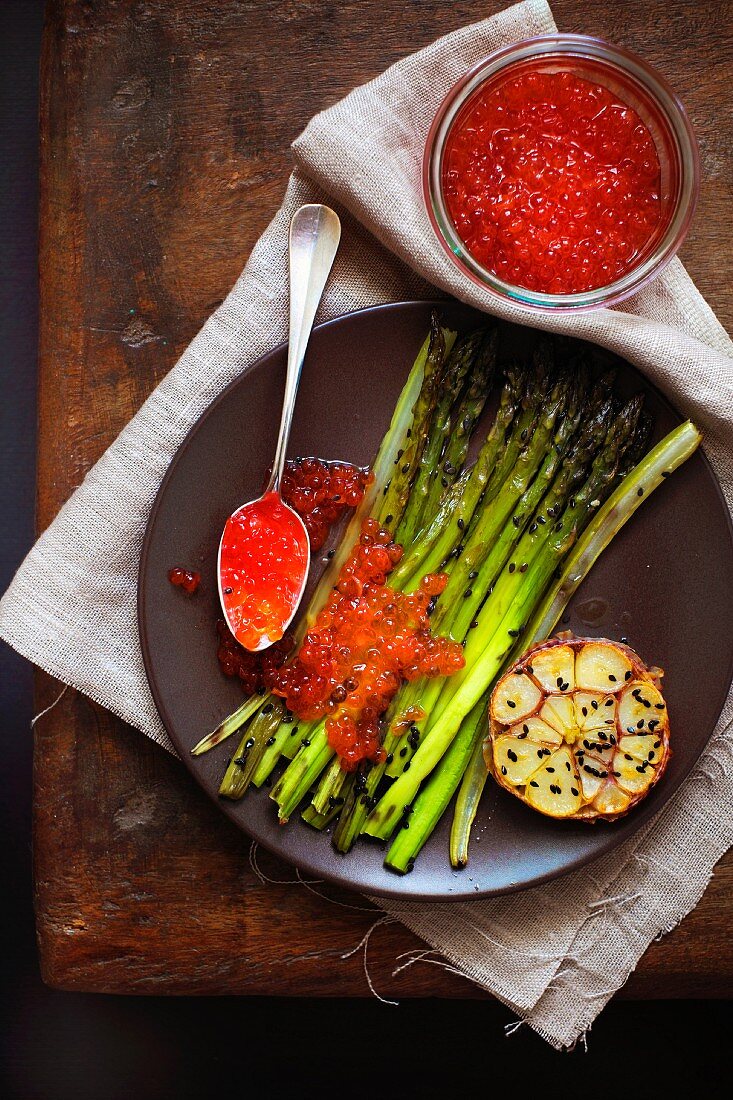 Roasted asparagus with red caviar and black sesame seeds
