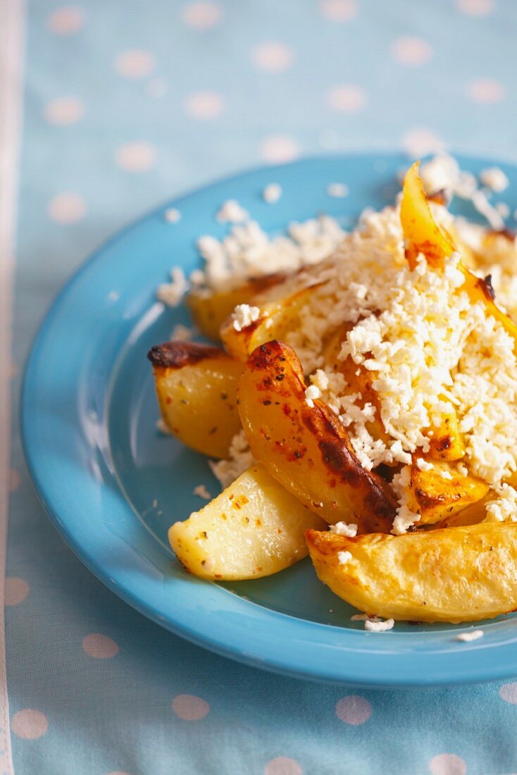 Oven-baked potatoes with herbs and grated feta