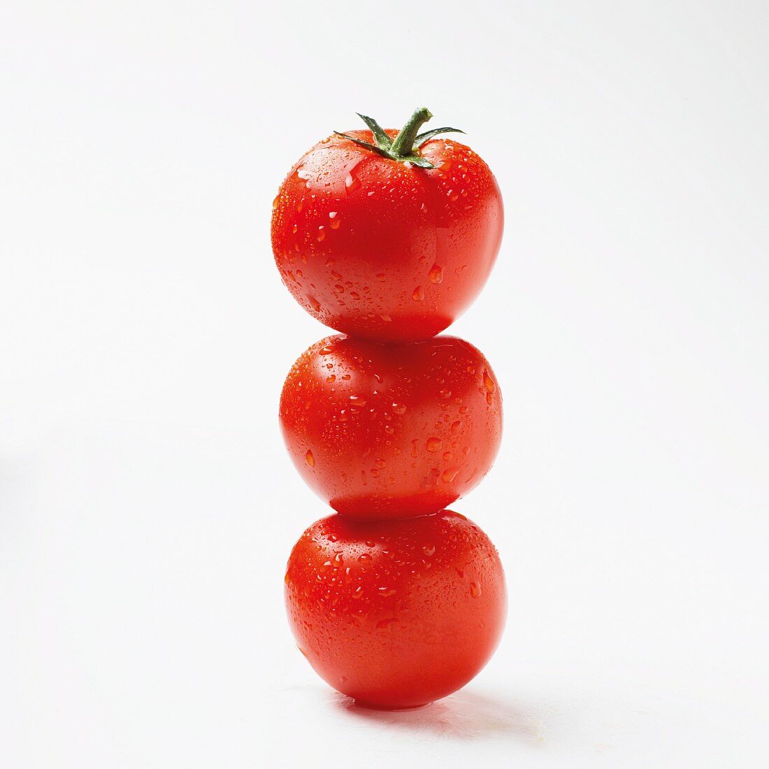 Three tomatoes, stacked