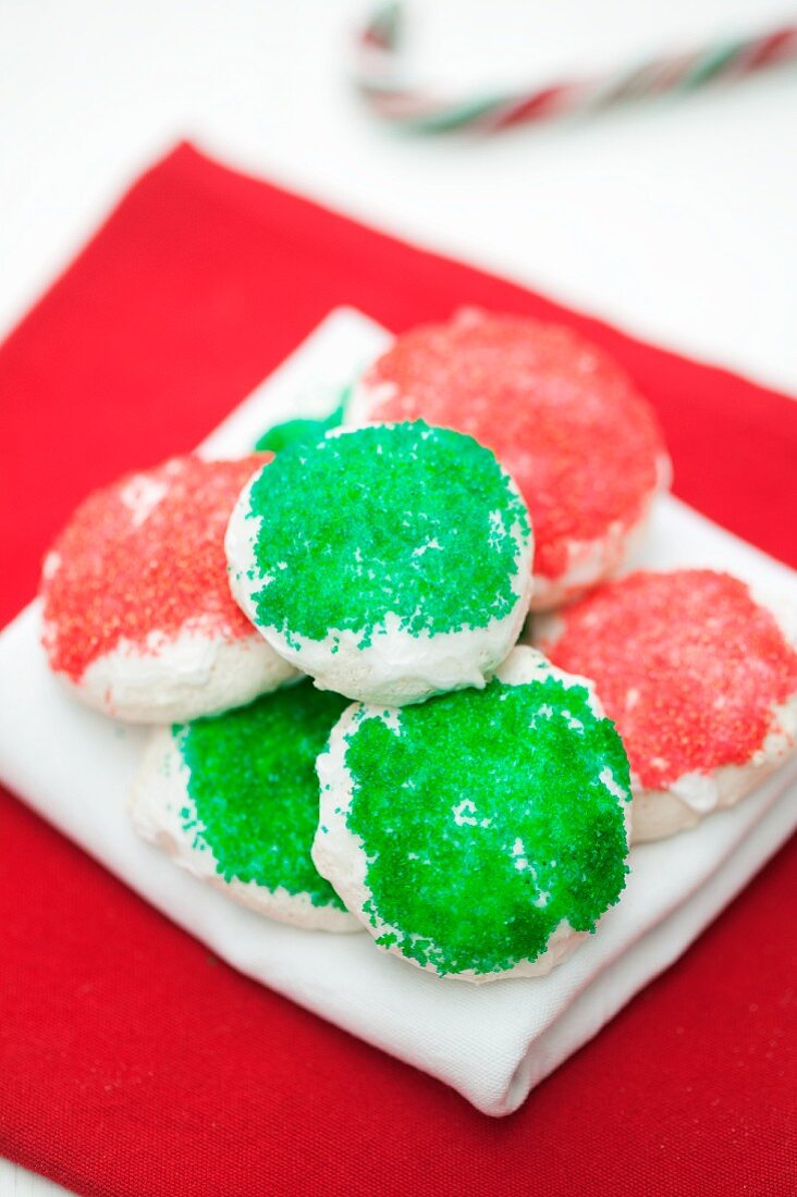 Meringue bites with green and red sugar decoration on a napkin