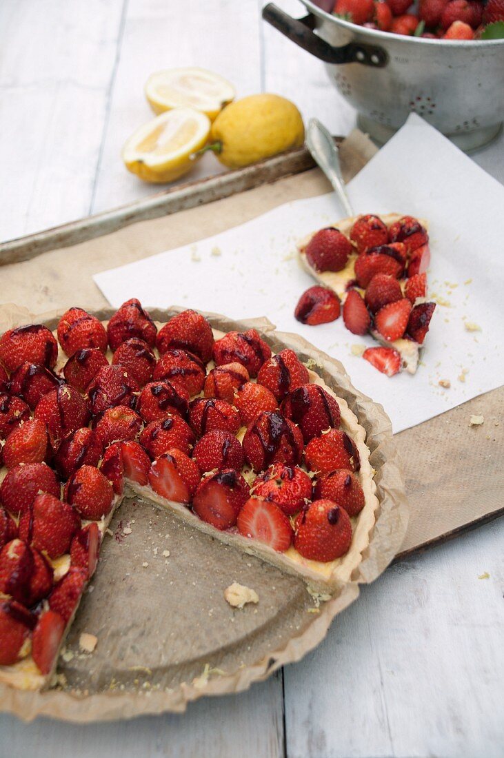 Strawberry and lemon tart, partly cut