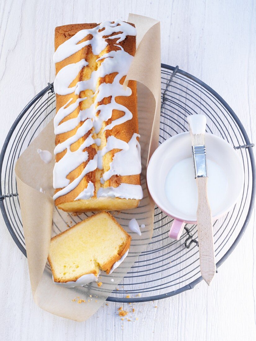 Lemon cake with glaze on a cooling rack