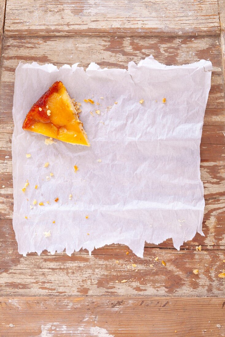 A slice of pear cake on grease-proof paper