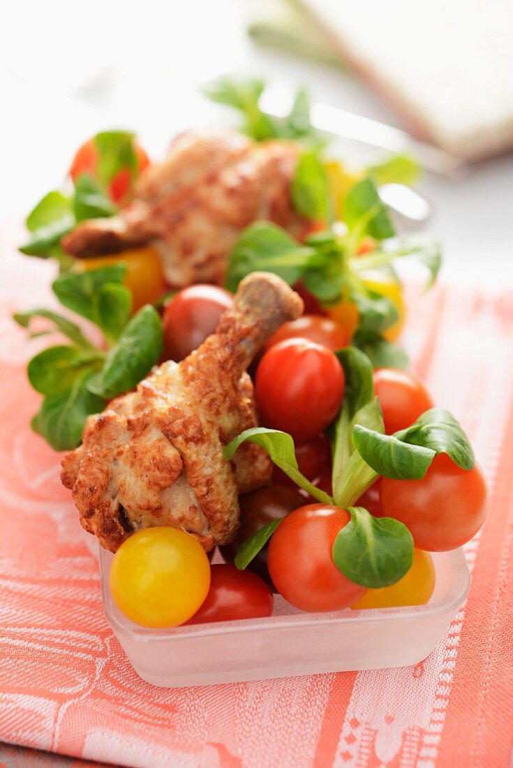 Chicken legs with cherry tomatoes and lamb's lettuce