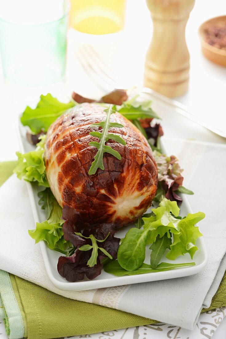 Rolled roast turkey with salad