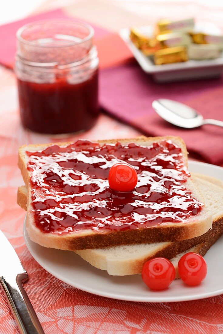 Sliced white bread with cherry jam