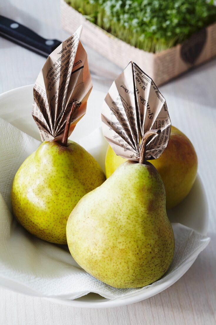 Pears decorated with newspaper leaves