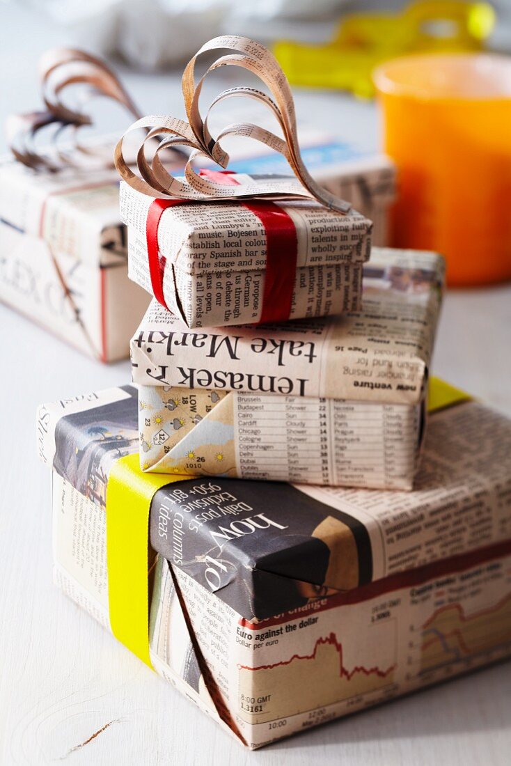 Gift boxes wrapped in newspaper with decorative hearts