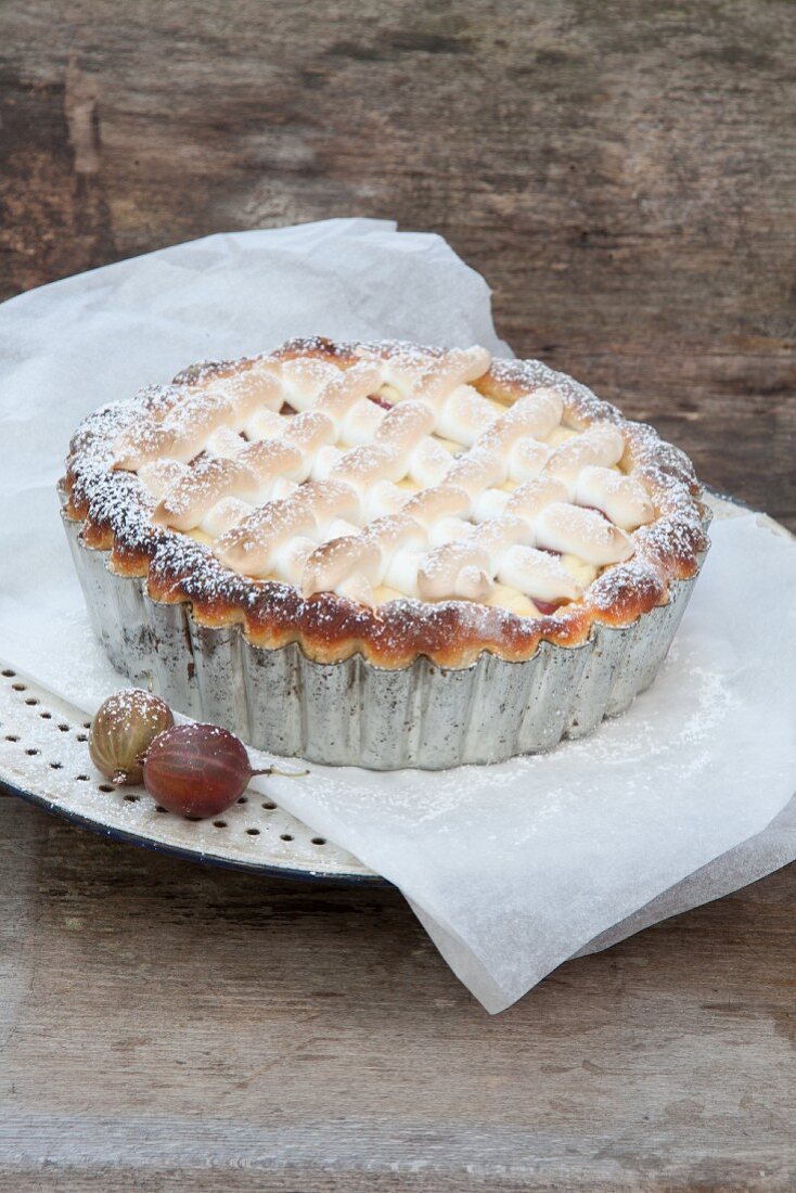 Gooseberry cake with a meringue top and icing sugar