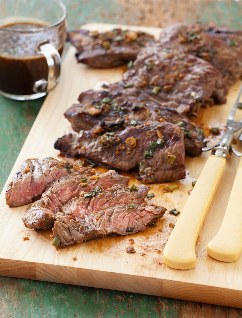 Sliced Grilled Skirt Steak on a Cutting Board