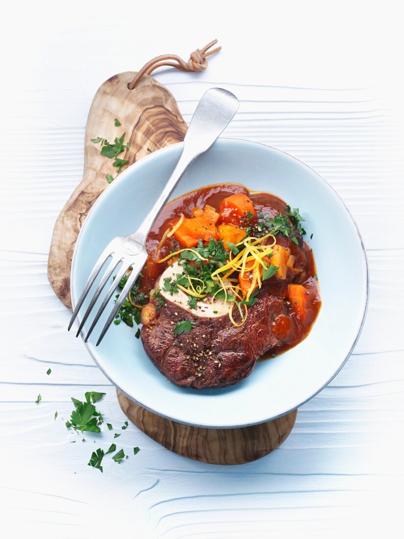Osso buco (stewed cross-cut veal shin) with carrots
