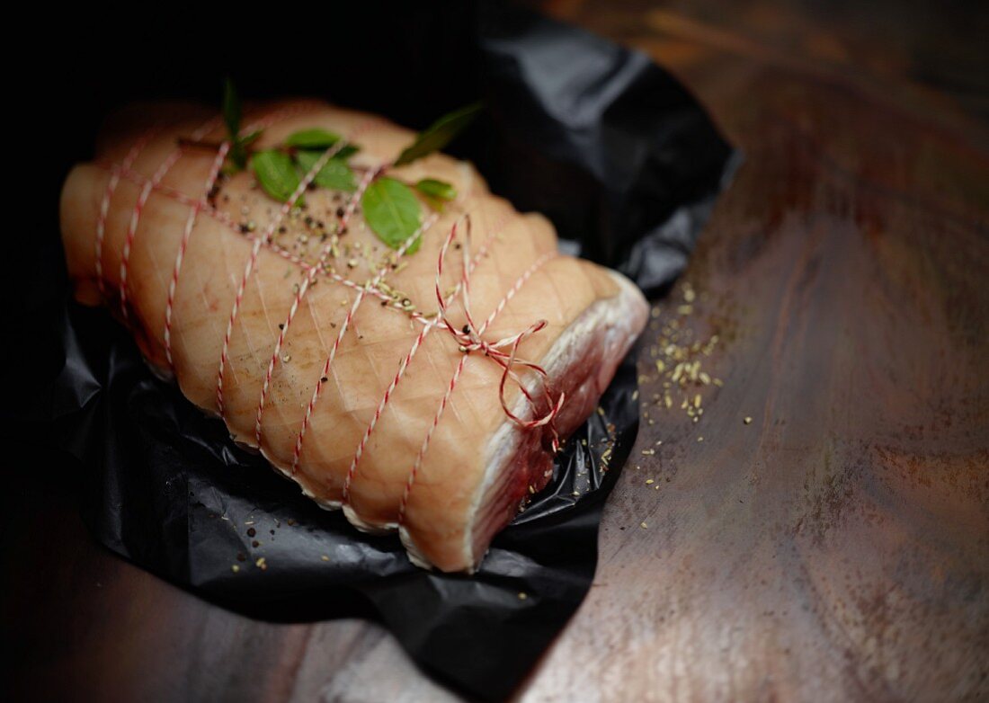 Rolled roast, tied, on wrapping paper ready for stewing