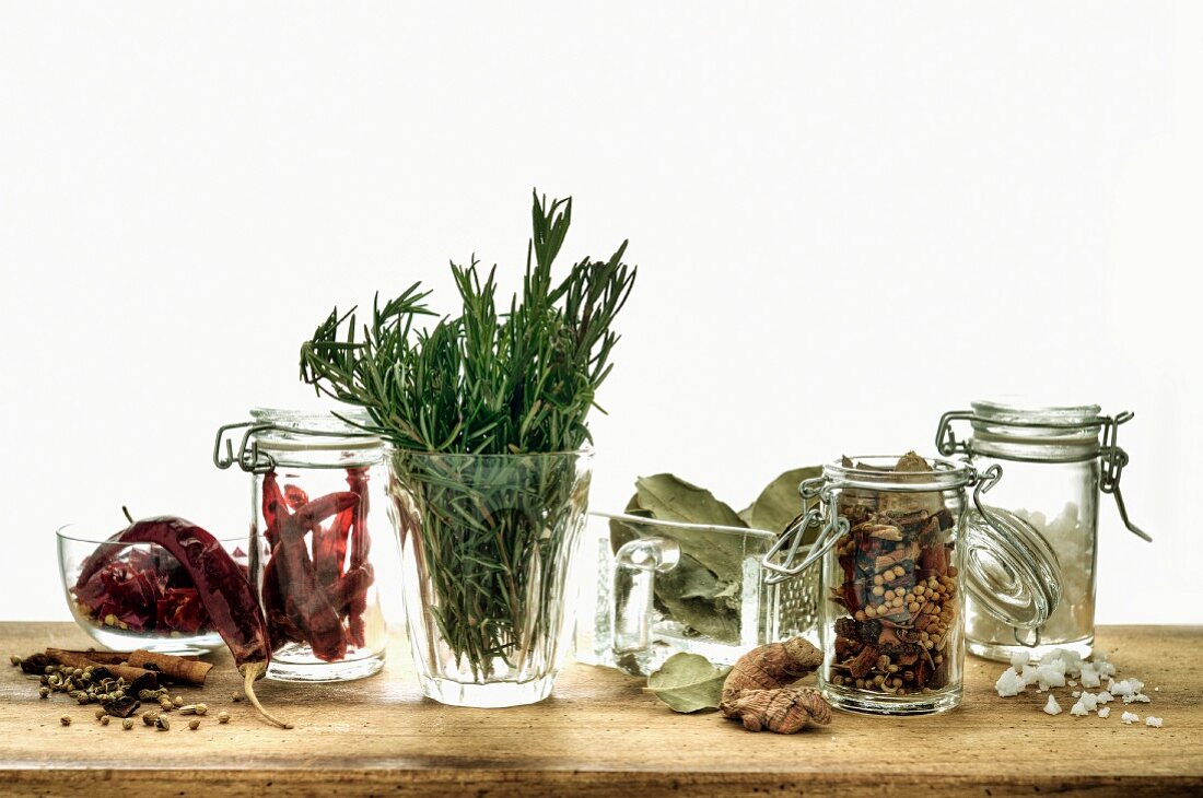 Sill life with assorted herbs and spices in glass containters