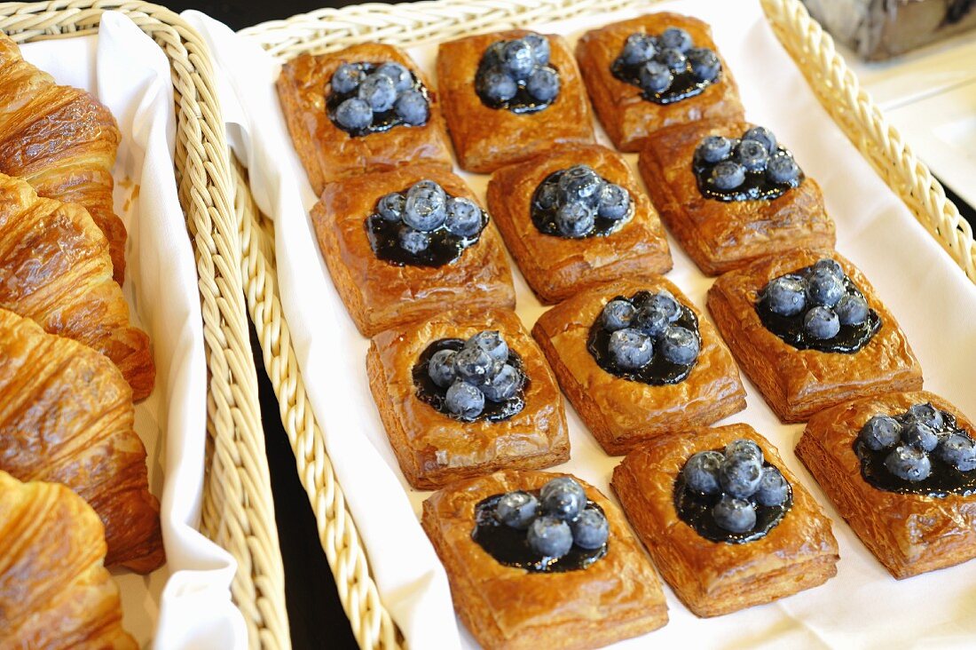 Danish pastries with blue berries in a bakery window