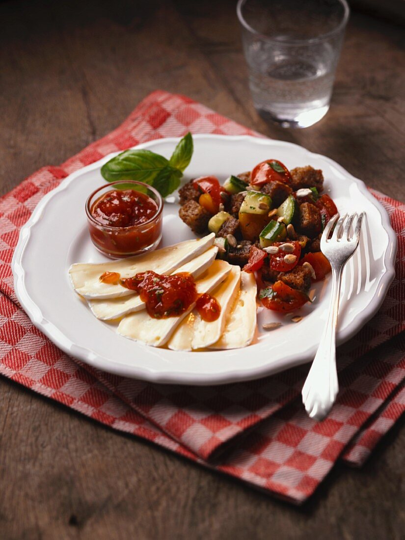 Rustic bread salad with soft cheese and marmalade