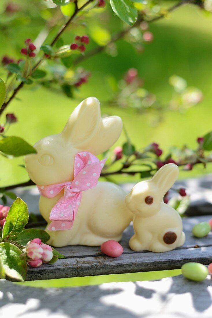 White chocolate bunnies in a springtime garden