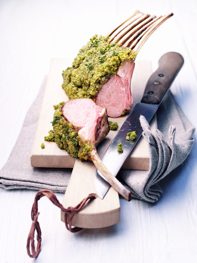 Lamb cutlets with a pistachio crust on a cutting board