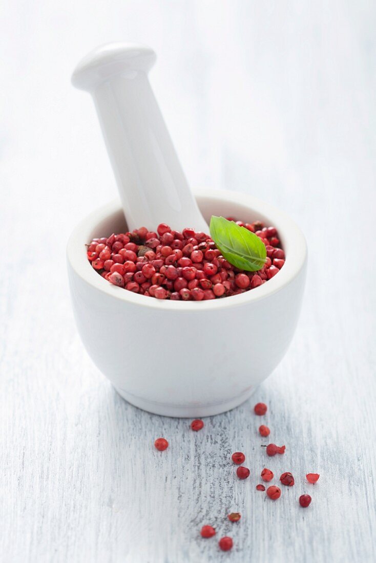 Pink peppercorns in a mortar