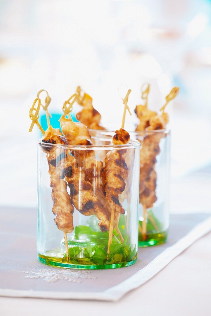 Chicken satay skewers with honey in glasses