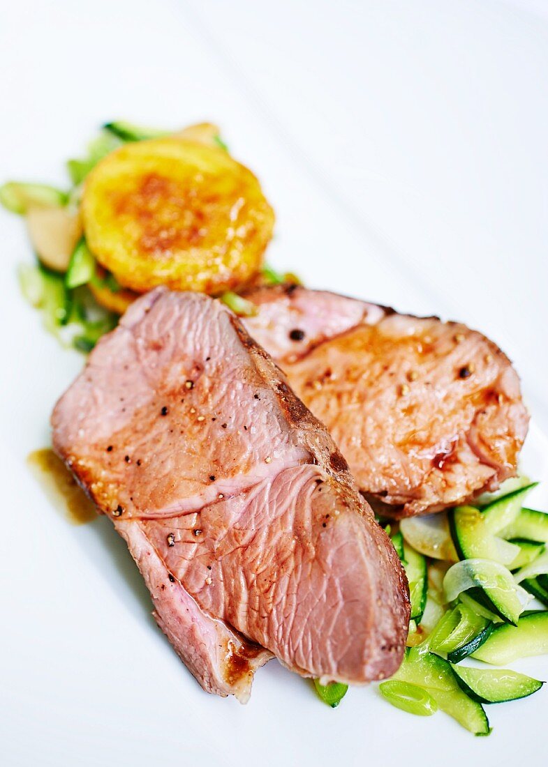Roast lamb on a bed of courgette