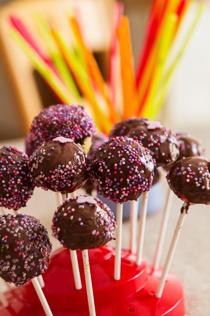 Cake pops with dark chocolate icing and sugar pearls