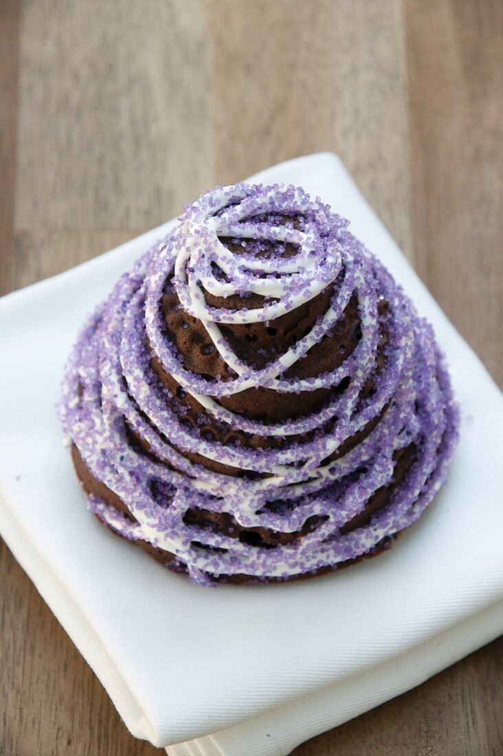 Chocolate cake with squash and ginger decorated with purple sugar