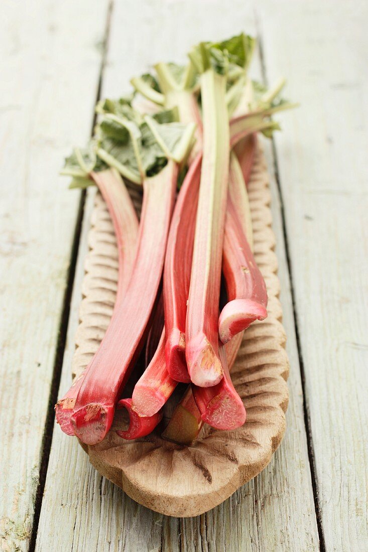 Rhubarb stalks on a wooden serving platter