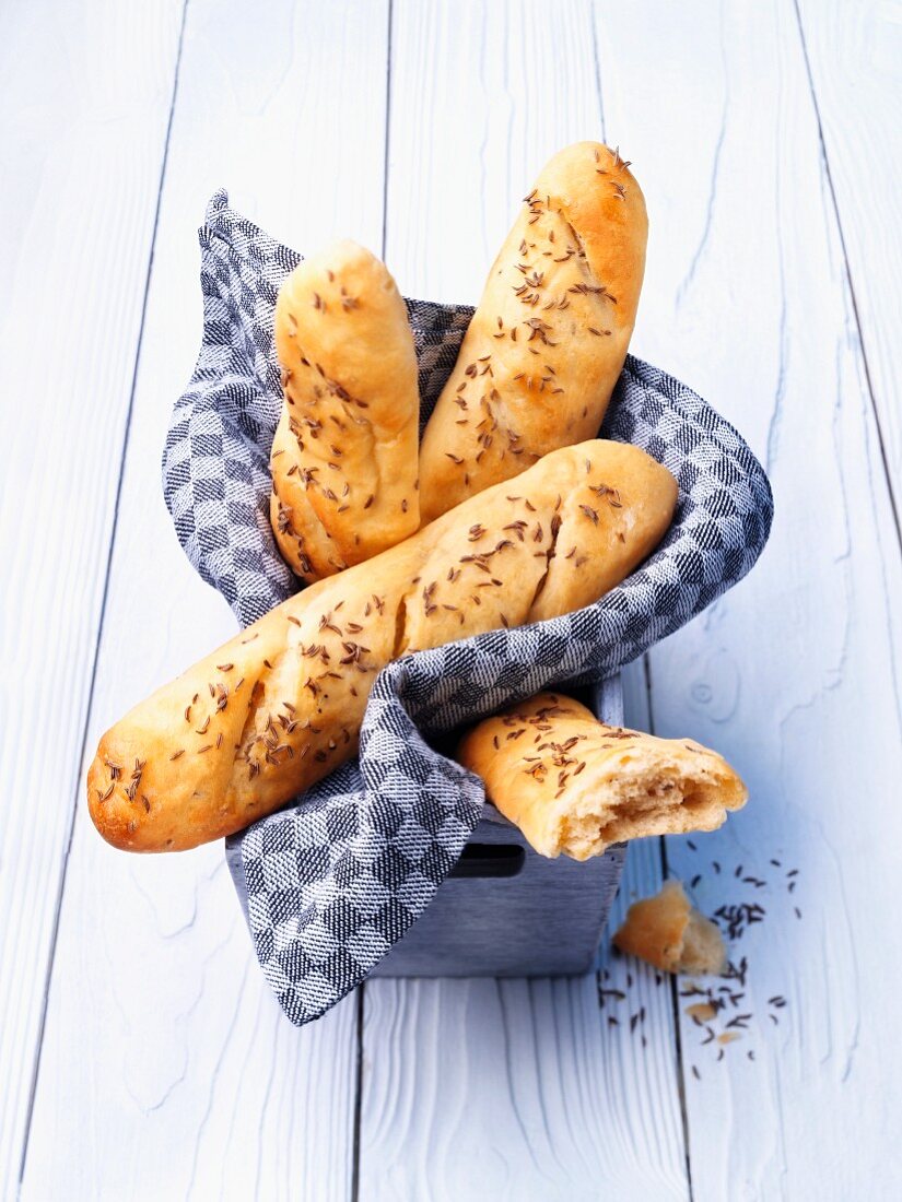 Beer bread baguette rolls with caraway seeds in a bread basket