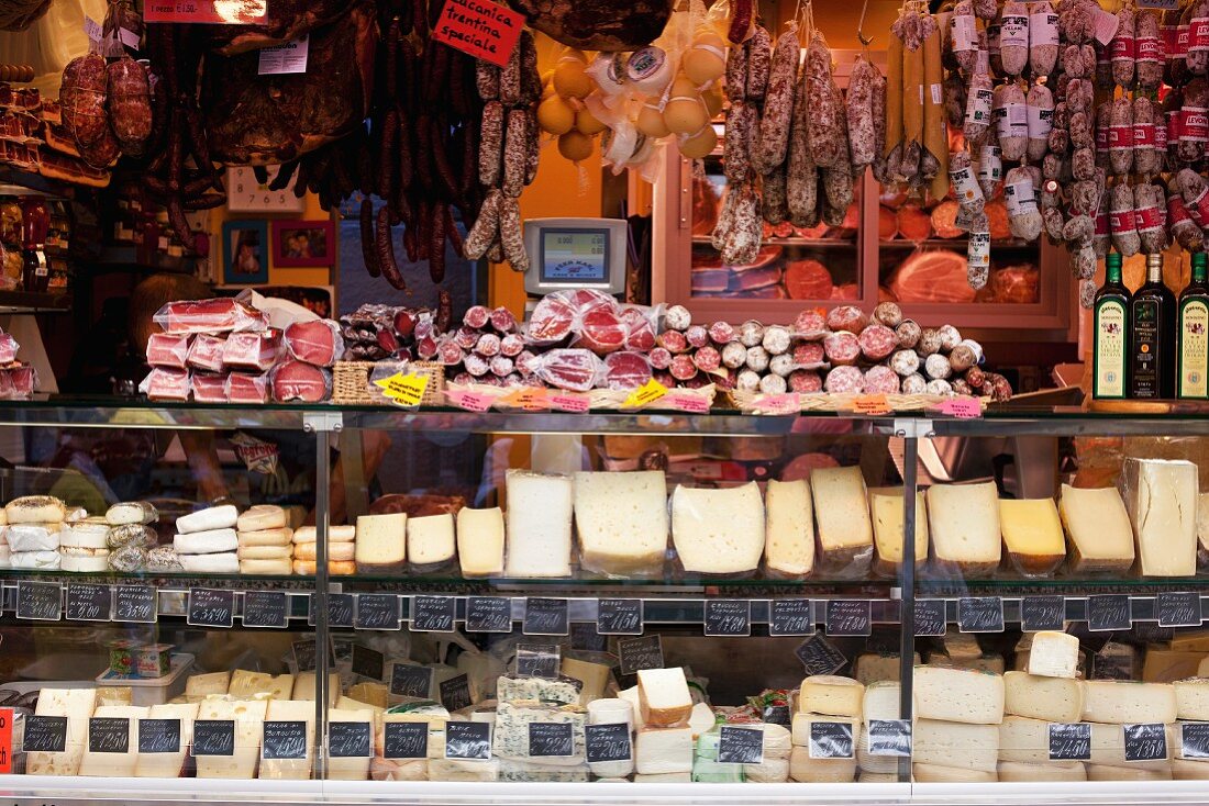 A cheese counter and sausages in a shop