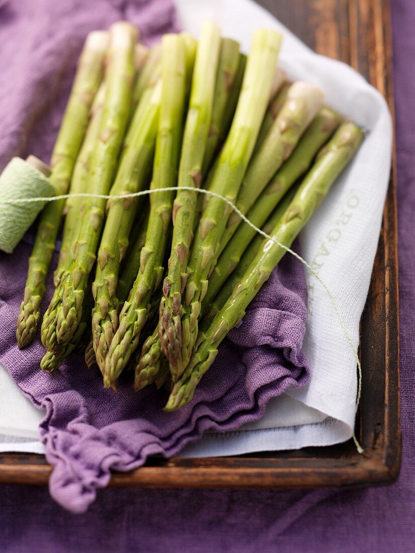 Green asparagus on a purple cloth