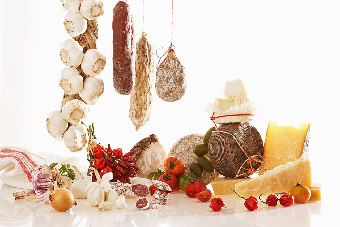 A still life featuring Italian sausage and cheese varieties