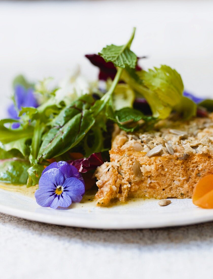 A slice of pumpkin bake with a side salad