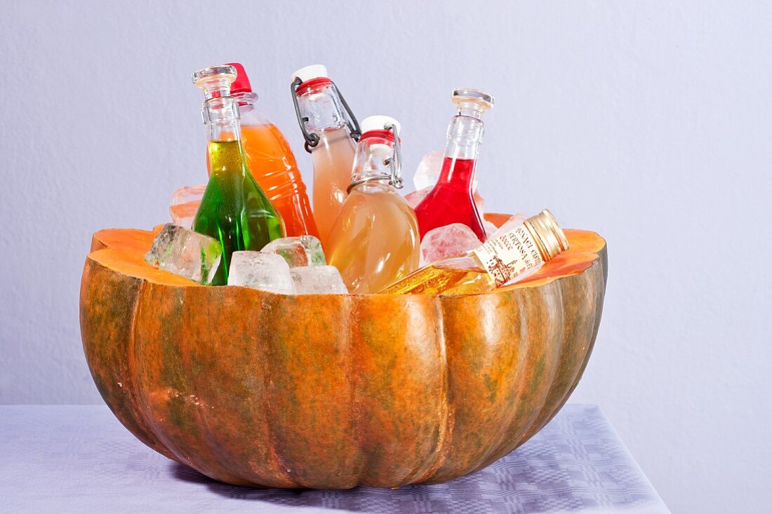 A hollowed out pumpkin as a bottle cooler
