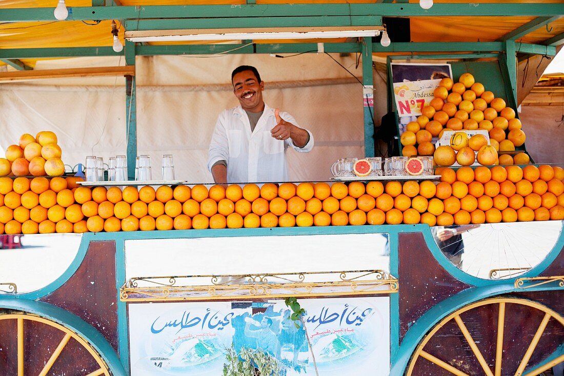 A North African man selling freshly squeezed orange juice