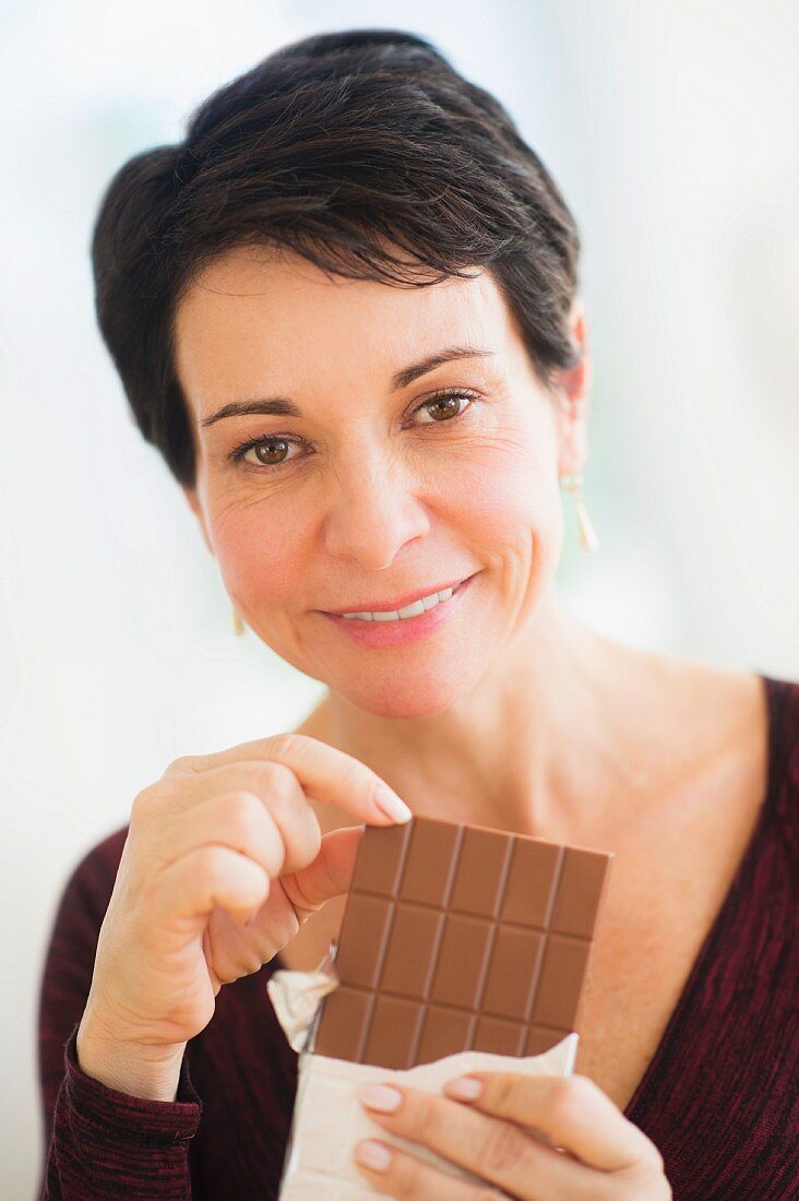 A woman holding a bar of chocolate