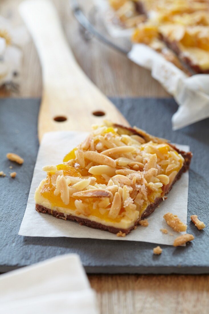 A portion of apricot tart with slivered almonds