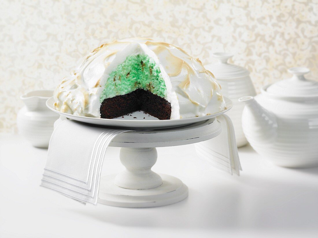 Baked Alaska (ice cream layer cake with meringue dome), sliced open