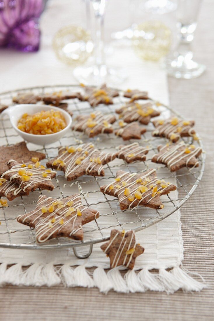 Chocolate orange star-shaped biscuits on a cooling rack