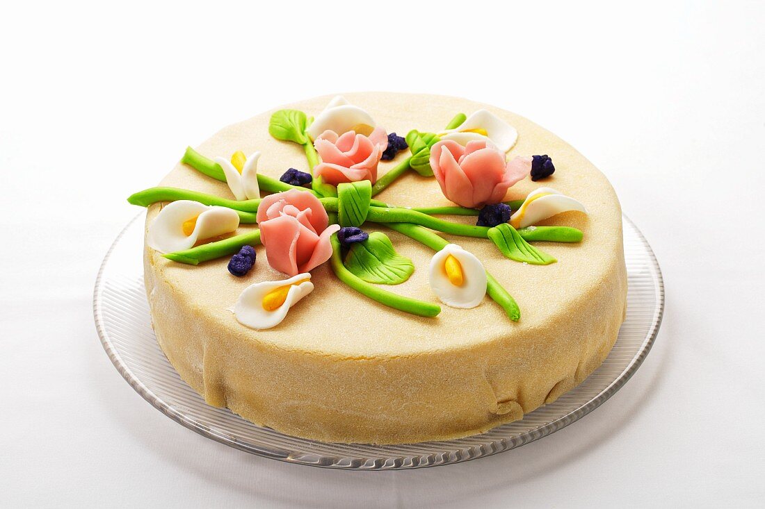 Elegant marzipan layer cake with marzipan flowers