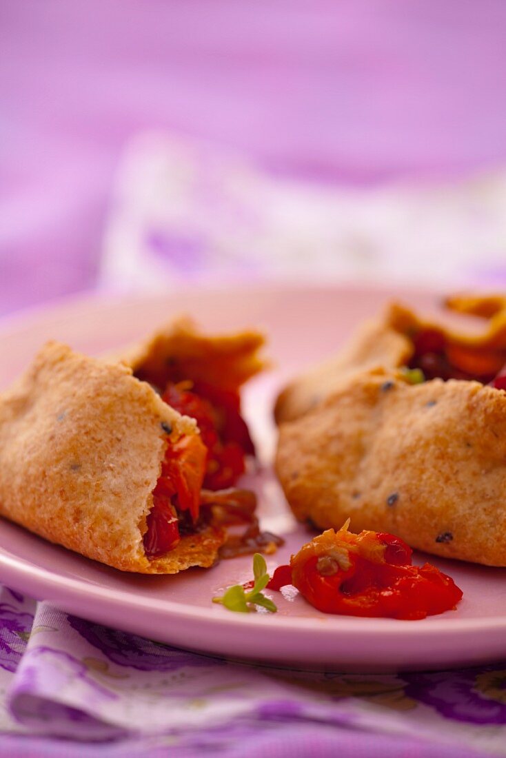 Wholemeal pastry parcels with pepper and onion filling, halved