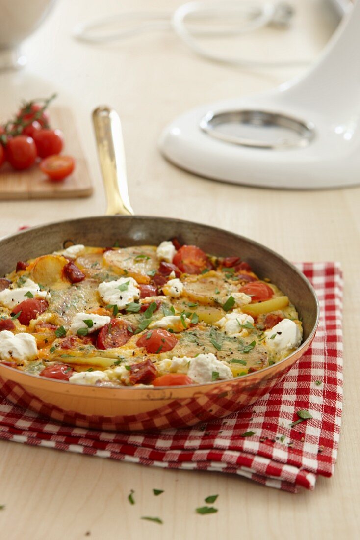 Pan-fried Spanish omelette with tomatoes and feta