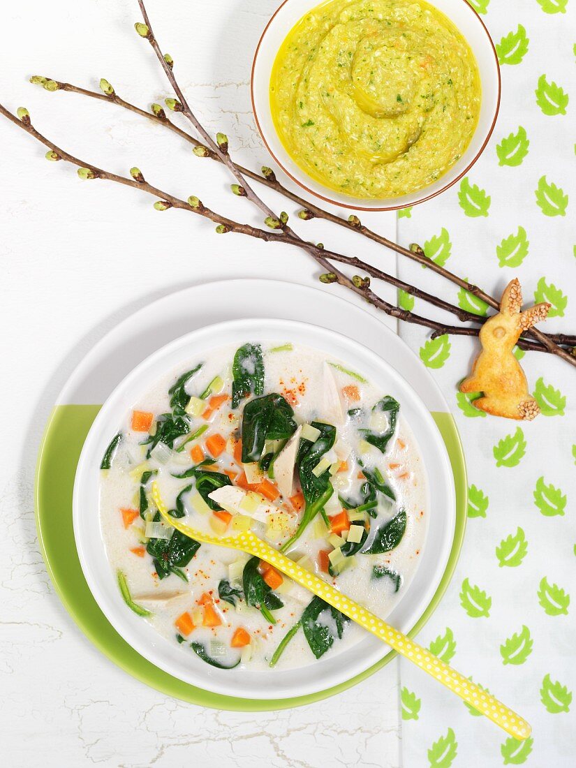 Exotic chicken soup with coconut milk and spinach, rabbit-shaped biscuits and baby food
