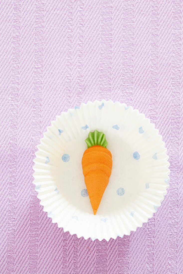 A paper case with a marzipan carrot