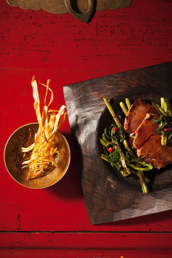 Fillet of beef with water spinach and deep-fried strips of ginger