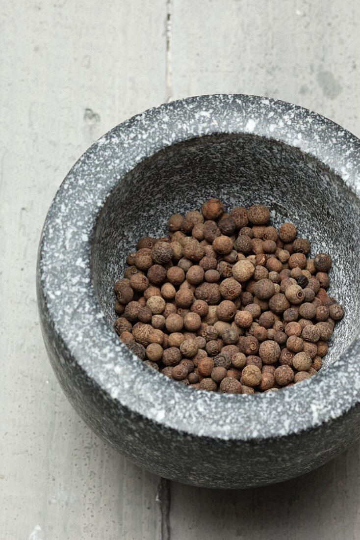 Allspice berries in a mortar