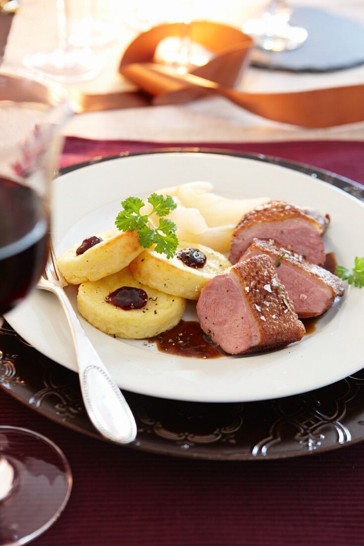 Duck breast with fried potato dumplings and cranberry sauce