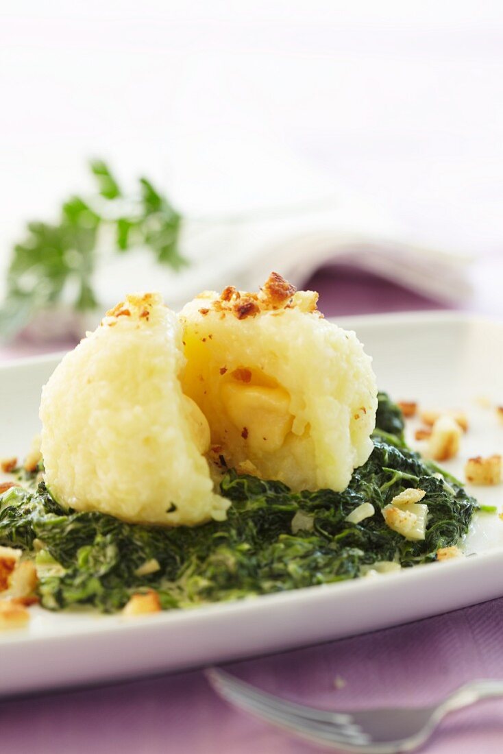 A potato dumpling on a bed of savoy cabbage